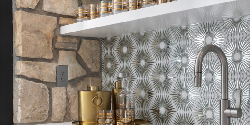 Beautiful, modern mountain home bar with natural stone and hammered metals.